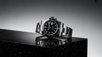 Close-up of a Rolex Submariner or Datejust watch, highlighting its classic design and refined details, with a luxurious Dubai backdrop.